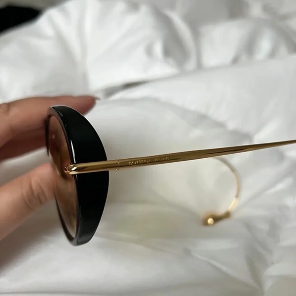 Bottega Veneta Black Frame Sunglasses with Yellow Lenses